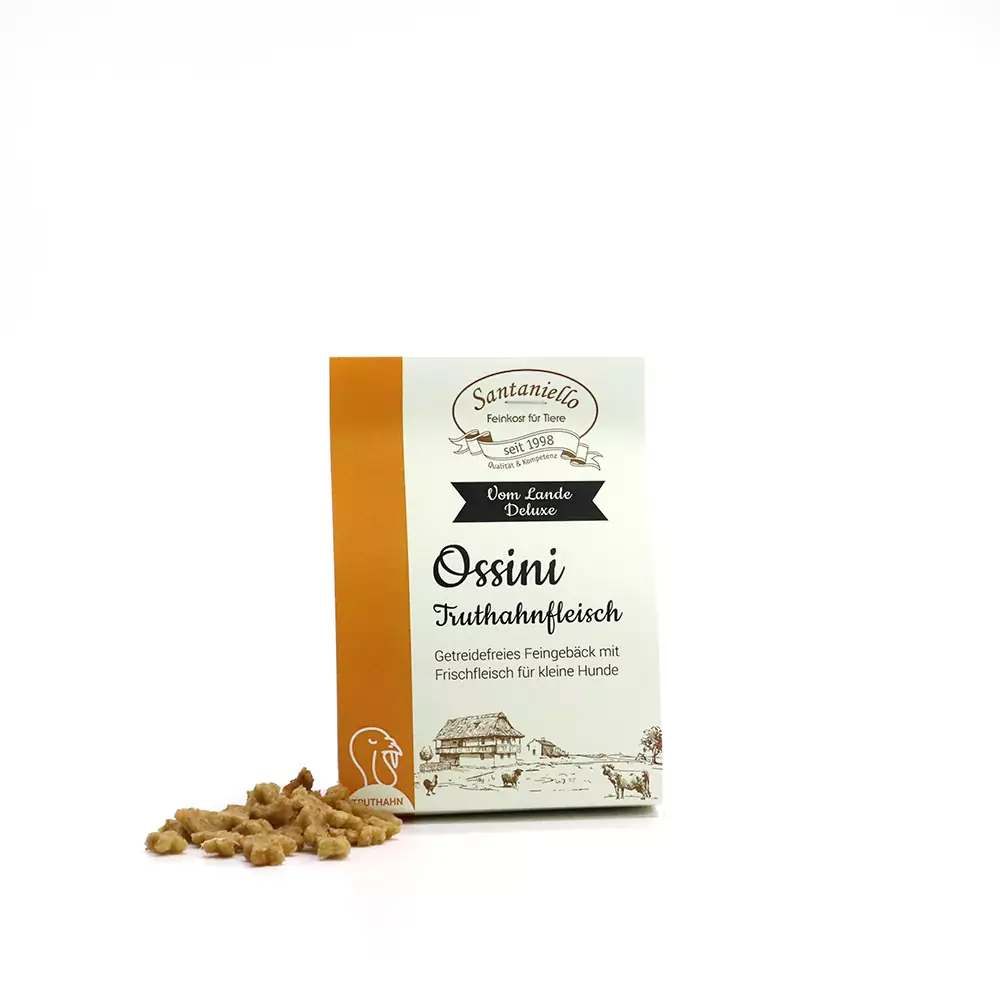 Confezione di Ossini Turkey Deluxe con snack per cani in primo piano.
