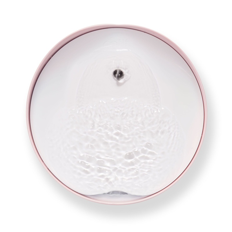 Round, pink-rimmed drinking bowl, filled with moving water and a small, dark ball in the centre.

