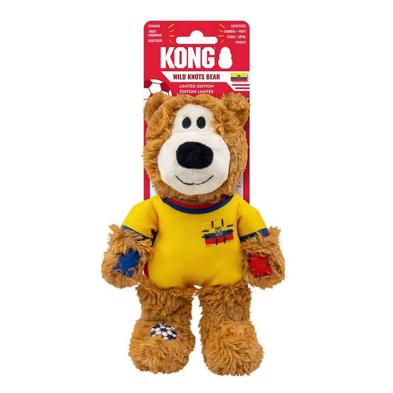 Orsacchiotto Kong marrone di peluche con maglia gialla e colletto a strisce rosse e blu. Sul petto un piccolo distintivo simile alla bandiera dell'Ecuador. Braccia con toppe blu e rosse; sul piede sinistro un pallone da calcio cucito.
