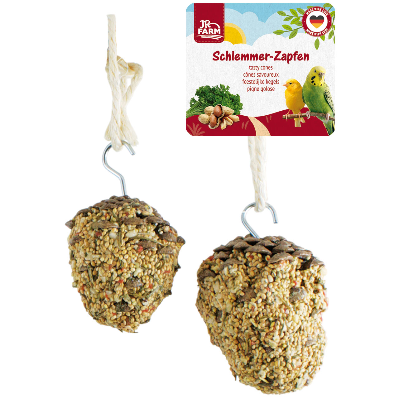Two bird feed cones, generously covered in seeds and grains, hang from cream-coloured cords and metal hooks against a white background. A label in the top right-hand corner reads ‘Schlemmer-Zapfen’, featuring a yellow bird and a green budgie.
