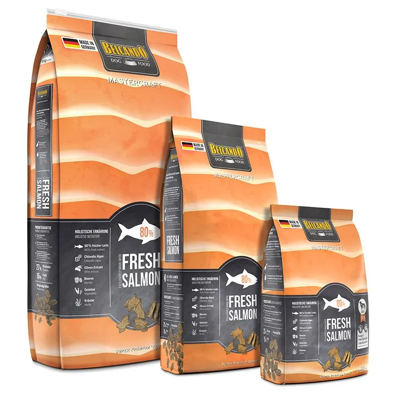 Three orange-coloured bags of Belcando Mastercraft dry dog food containing 80% fresh salmon, in various sizes. Features a fish symbol, kibble and ingredients such as chlorella algae, berries, vegetables and herbs. ‘Made in Germany’ clearly displayed.