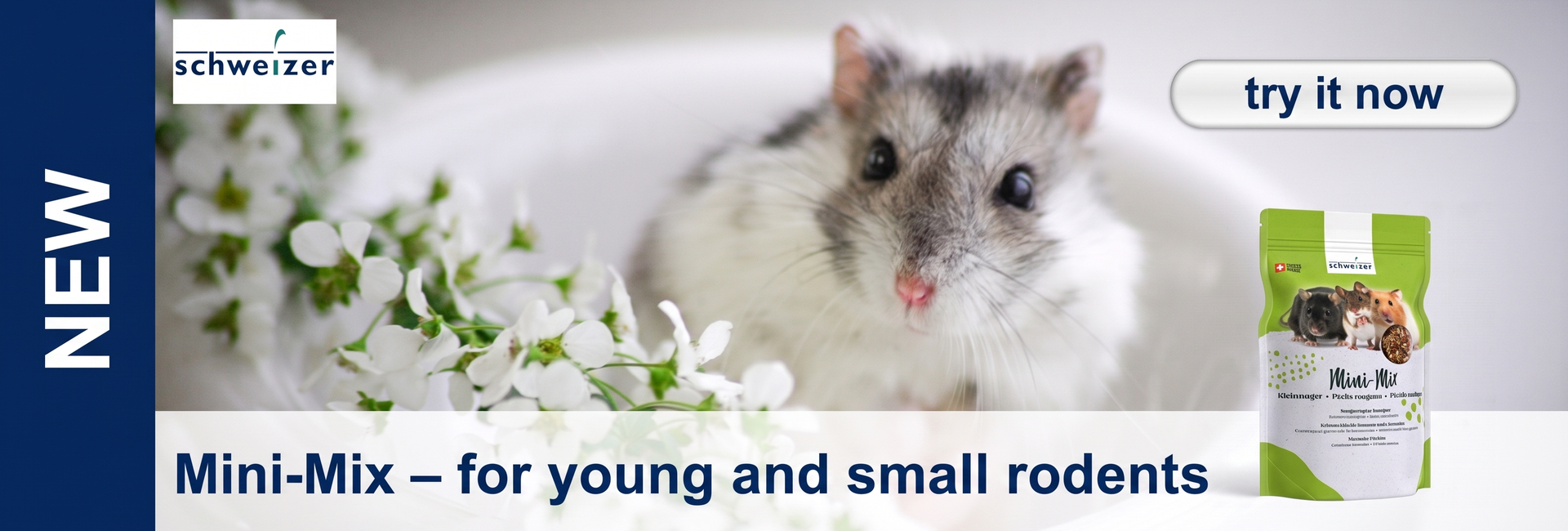 A small, fluffy dwarf hamster with grey-and-white fur against a light background, surrounded by delicate white flowers. On the right, a green packet of ‘Swiss Mini-Mix’ pet food. Top right: ‘try it now’; top left: ‘NEW’.