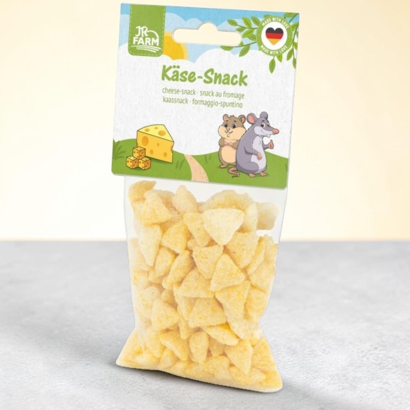 Transparent bag containing yellow, triangular JR Farm cheese snacks. Top panel featuring the product name ‘Cheese Snack’ and illustrations: a large wedge of cheese, three cubes, and two cartoon mice on a green hill. Top right: ‘Made with Love’ seal.