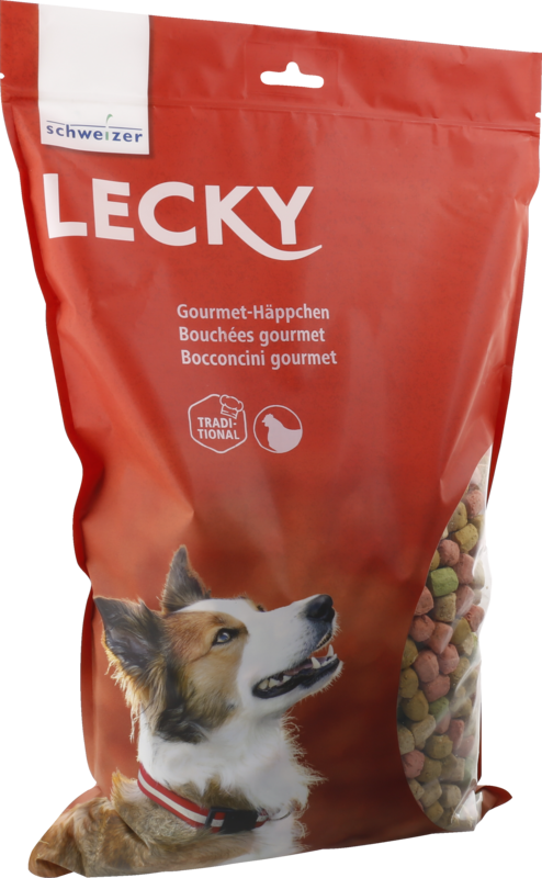 Emballage rouge des «Lecky Gourmet-Häppchen » avec une fenêtre montrant de petits biscuits colorés pour chiens. On voit aussi la tête d'un chien qui regarde vers le haut, comme s'il attendait ces friandises croustillantes.