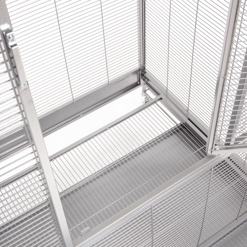 Detailed view of the grid base of a silver bird aviary.