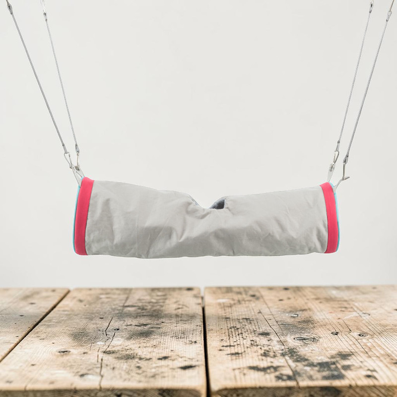 Grey cosy tunnel made from high-quality nylon for ferrets, rats or chinchillas, suspended from thin ropes with carabiners. The ends feature wide pink and narrow light blue fabric strips with a lambswool-like finish.