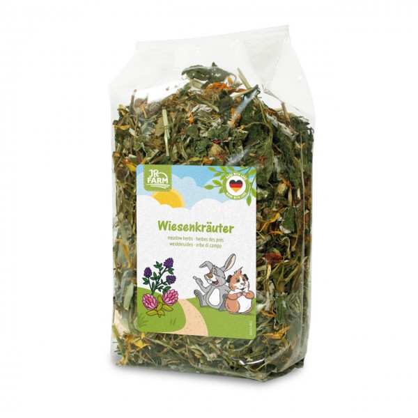 Transparent packaging with dried meadow herbs from JR Farm for small animals. Label shows two happy cartoon animals, a rabbit and guinea pig, on a background of purple clover. Top ‘Made with Love’ seal with German flag.