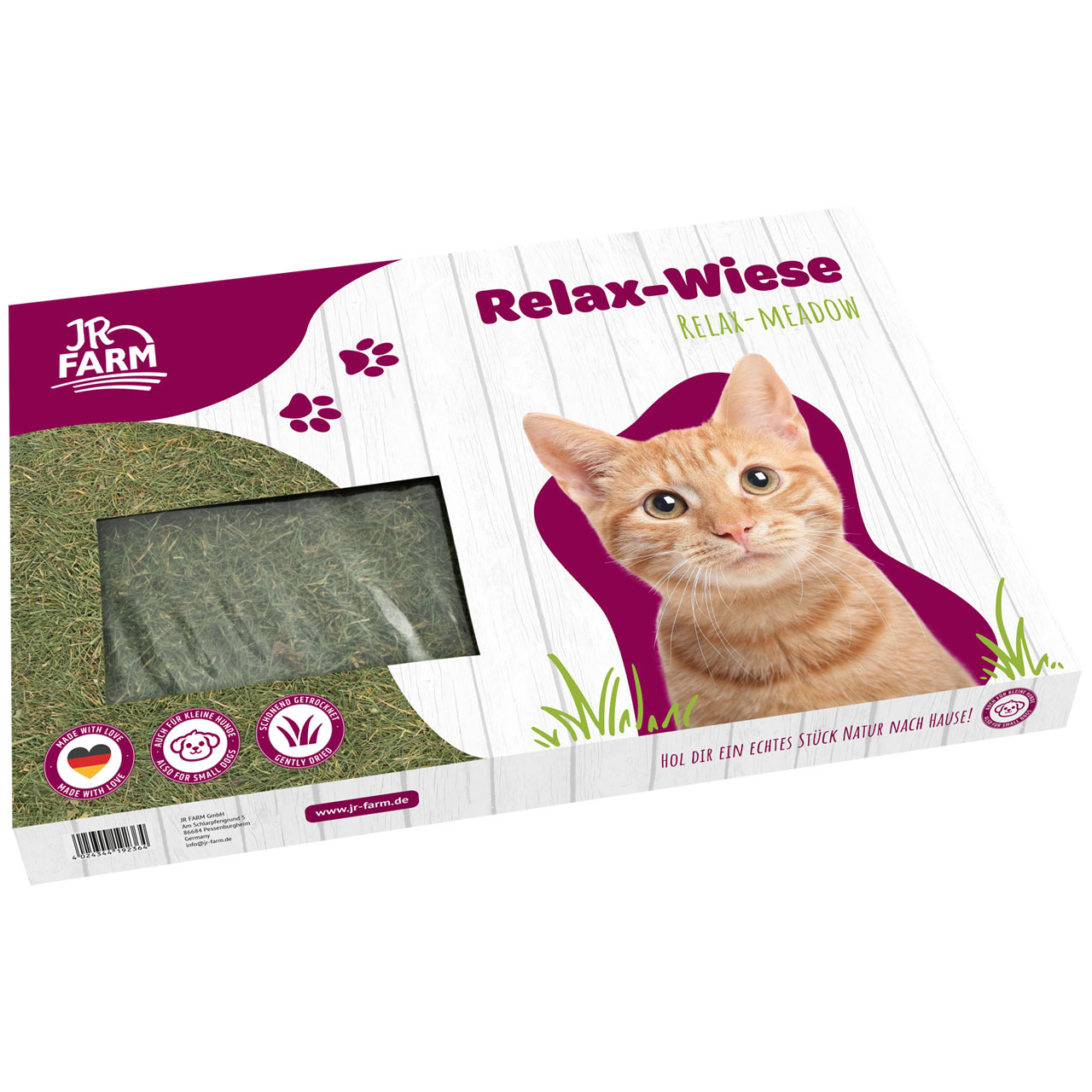 Packaging JR Farm Relax-Wiese (erba per gatti) davanti a una staccionata bianca. Un simpatico gatto rosso tigrato guarda incuriosito in alto a destra. Finestra con erba fresca. Scritte: «Made with Love», «Anche per cani di piccola taglia».