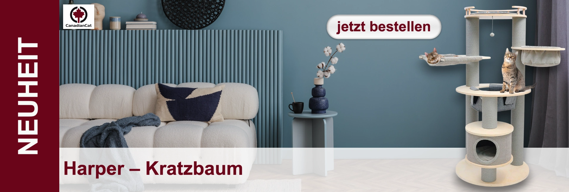 Arredamento con divano, tavolino e grande tiragraffi con due gatti sopra.