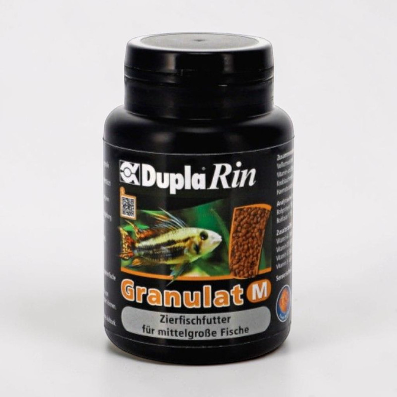 A black cylindrical plastic container with a black screw-on lid is shown on a light-coloured background. The label reads ‘Dupla Rin’ at the top, with a striped ornamental fish below, brown granules and ‘Granulat M’.