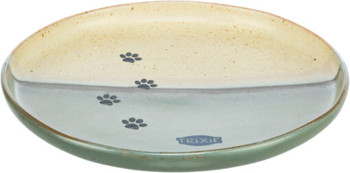 Ciotola ovale bicolore in ceramica per animali domestici: parte superiore beige chiaro, parte inferiore verde chiaro. Sul confine, quattro impronte di zampe nere in diagonale. In basso a destra logo Trixie blu scuro. Bordo smaltato rustico marrone-verde.