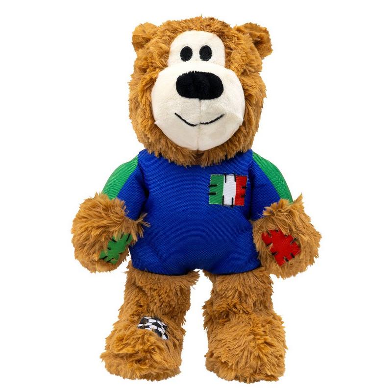 Orsacchiotto di peluche marrone con maglietta blu e maniche verdi. Sul petto una toppa con i colori della bandiera italiana. Toppe sulle zampe e sui piedi: verde a sinistra, rossa a destra, piede sinistro a scacchi bianchi e neri.