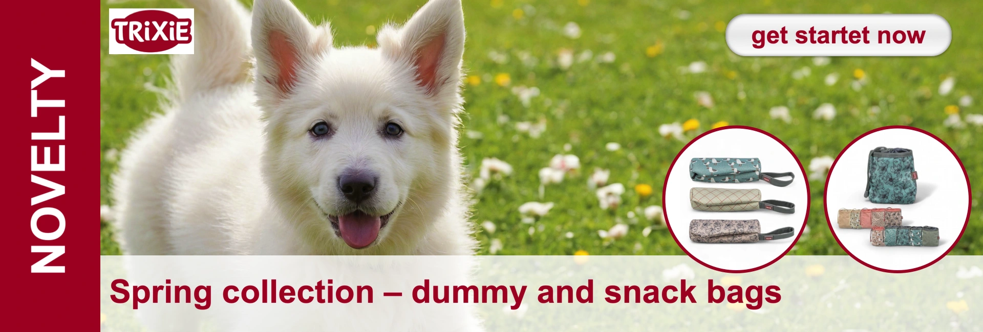A white German shepherd puppy is lying in the grass and next to it are dummy and snack bags for dogs.