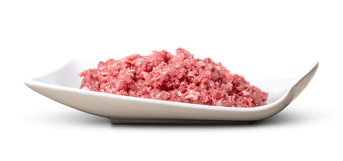 A pile of raw minced meat, loosely arranged on an elegantly curved white platter. The meat is pale pink with small white flecks of fat visible and finely minced, ready for cooking. The background is pure white.