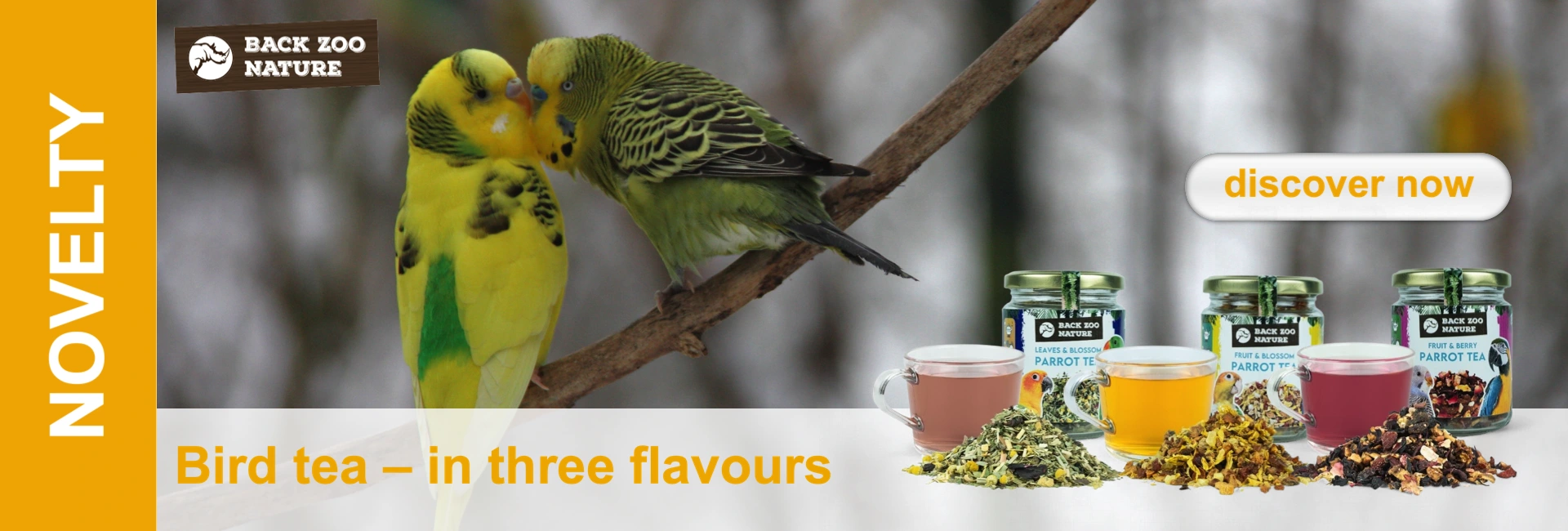 Two budgerigars sit on a branch; in front of them three types of tea in glasses and cups.