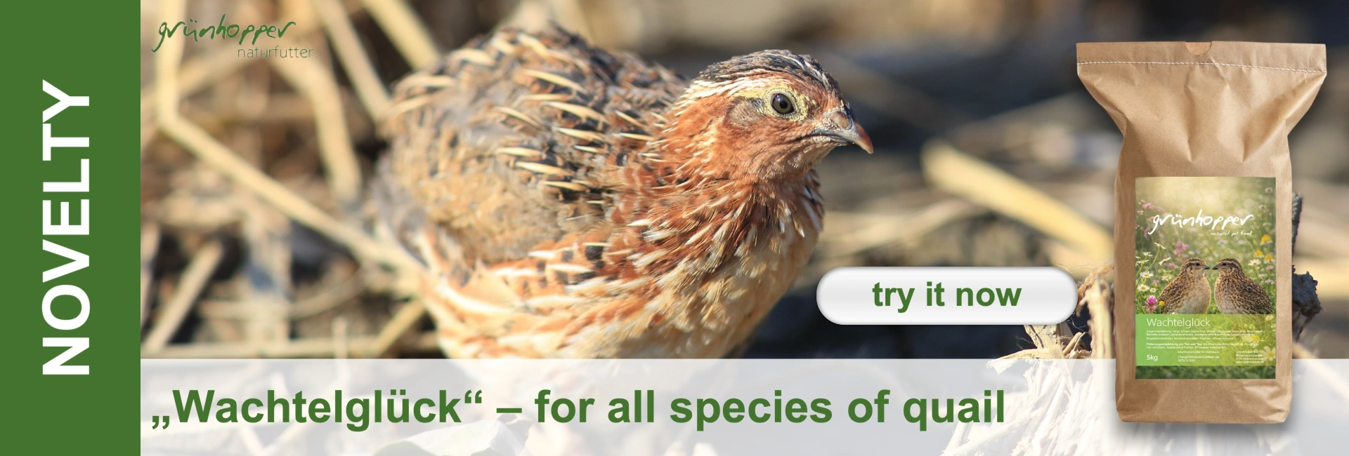 A European quail with brown, white and black plumage is looking to the right. In the background, hay or dry grass is out of focus. On the right is a brown paper bag of quail feed with a label showing two quails in a flower-filled meadow.