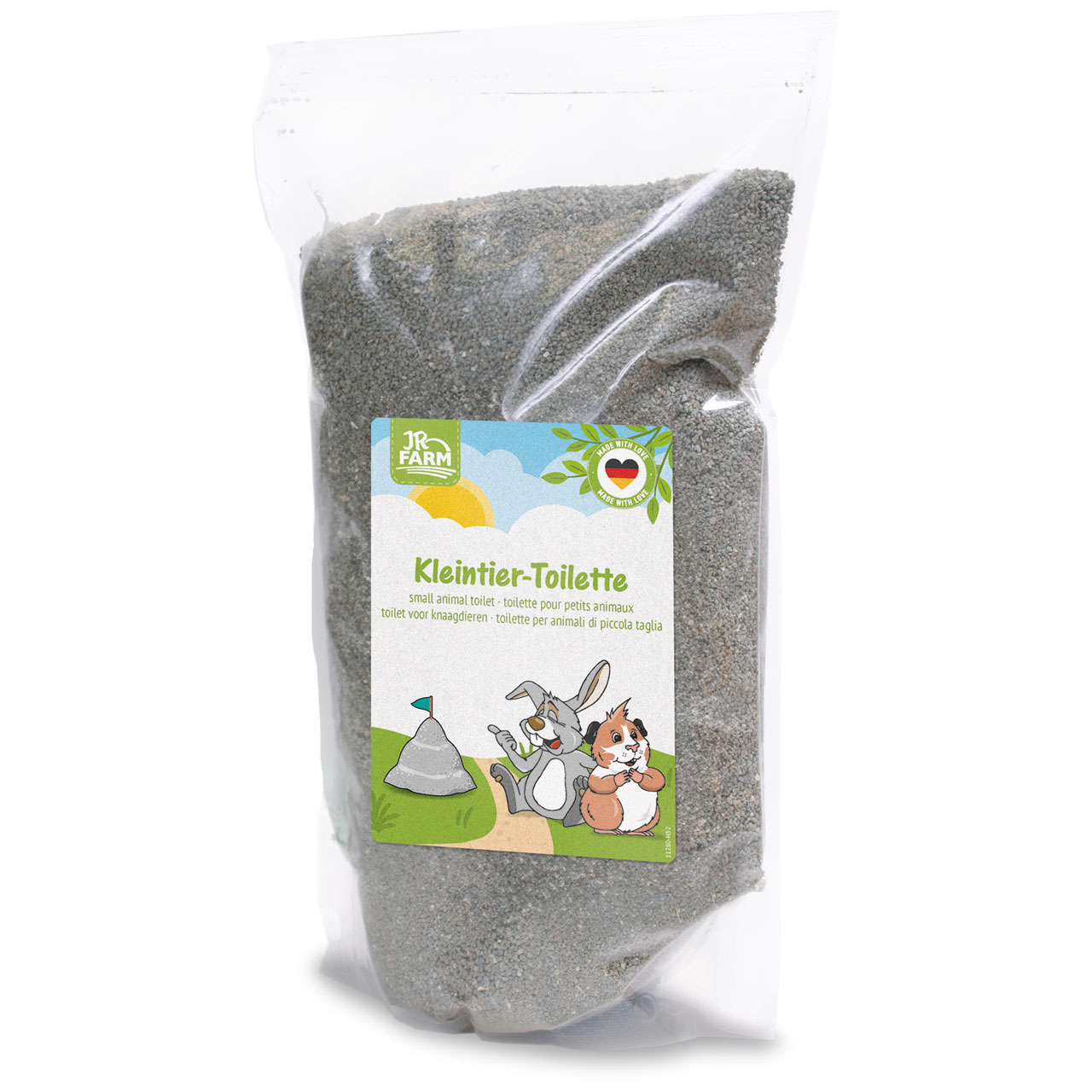 Transparente Plastikverpackung mit feinem grauem Granulat (vermutlich Kleintierstreu/-sand). Etikett: "JR FARM Kleintier-Toilette" mit Hase und Meerschweinchen neben grauem Hügel unter sonnigem Himmel. "Made with love"-Siegel mit Deutschlandflagge.