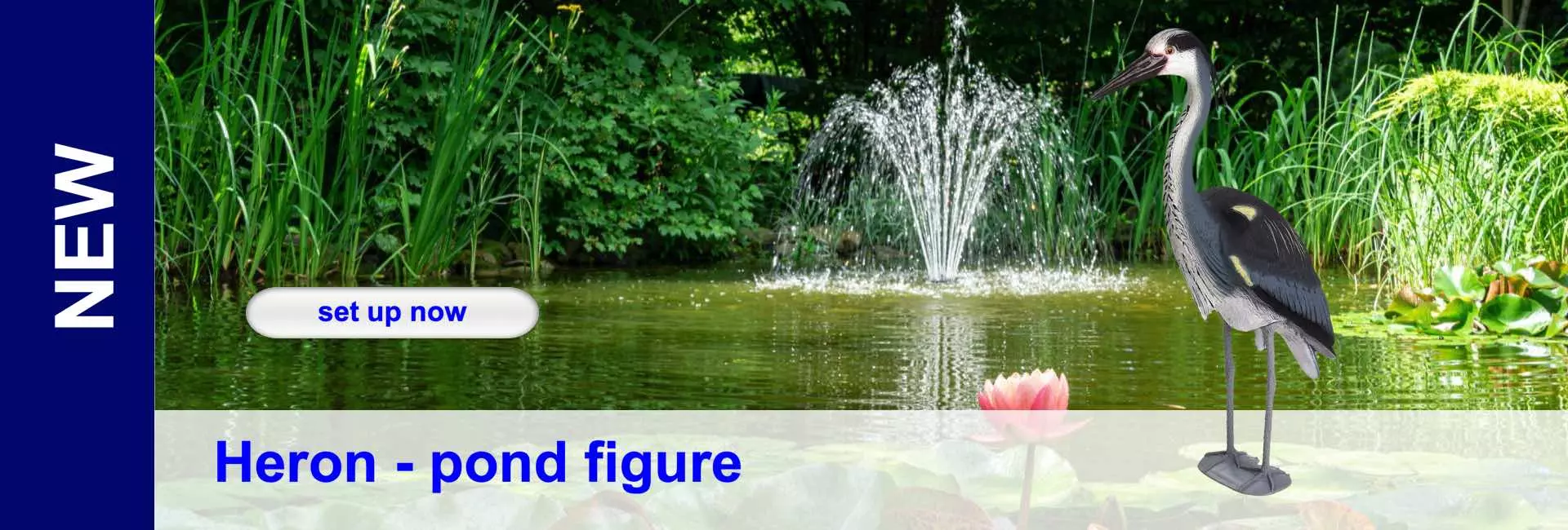 Pond scene with heron figure next to water lily and fountain. Lush green vegetation in the background.