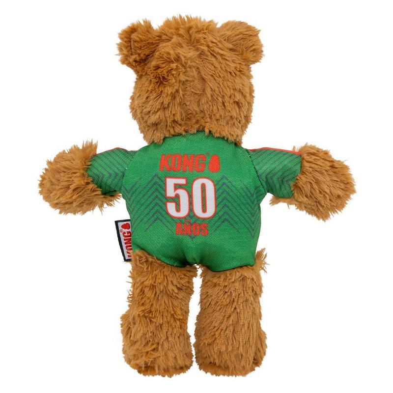 Morbido orsacchiotto marrone visto da dietro, indossa una maglietta verde. Sulla schiena, in grandi lettere rosse, la scritta "Kong 50 AÑOS", con il "50" in evidenza. A destra, piccolo ciondolo bianco con la scritta "Kong'S". Sfondo bianco.