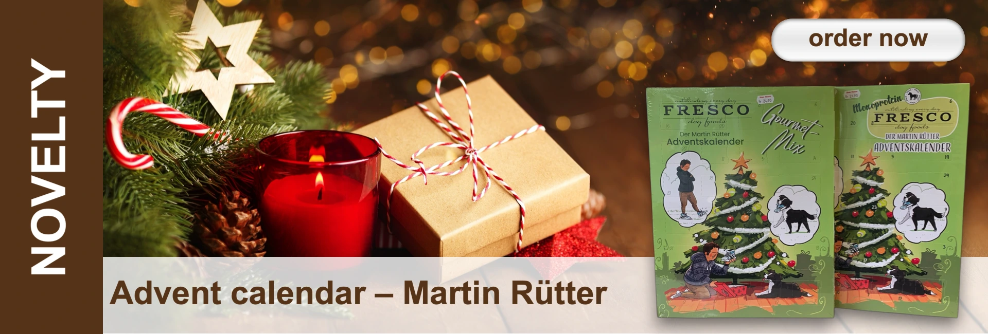 Christmas scene with candle, present, fir branch, candy cane and dog advent calendar against a bokeh background.